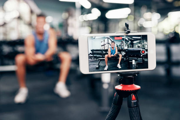 Phone on a tripod filming a lifter recording gym content